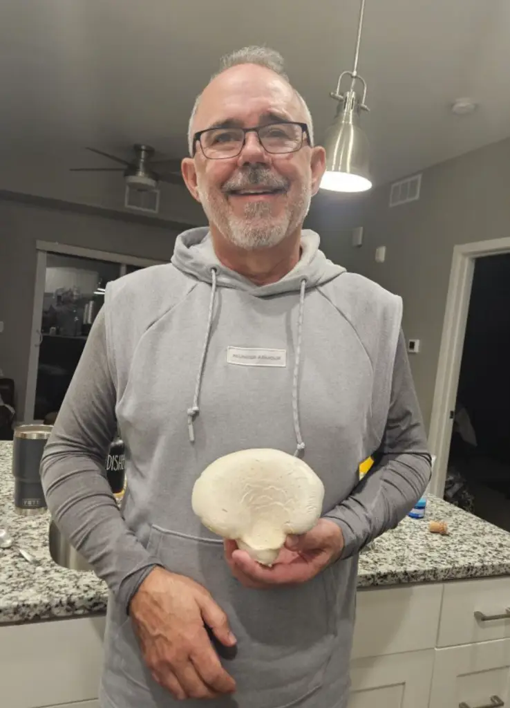 Jim Case, owner of Pebble Creek Produce in Michigan, holding a rarely cultivated nebrodini bianco (white elves) mushroom.
